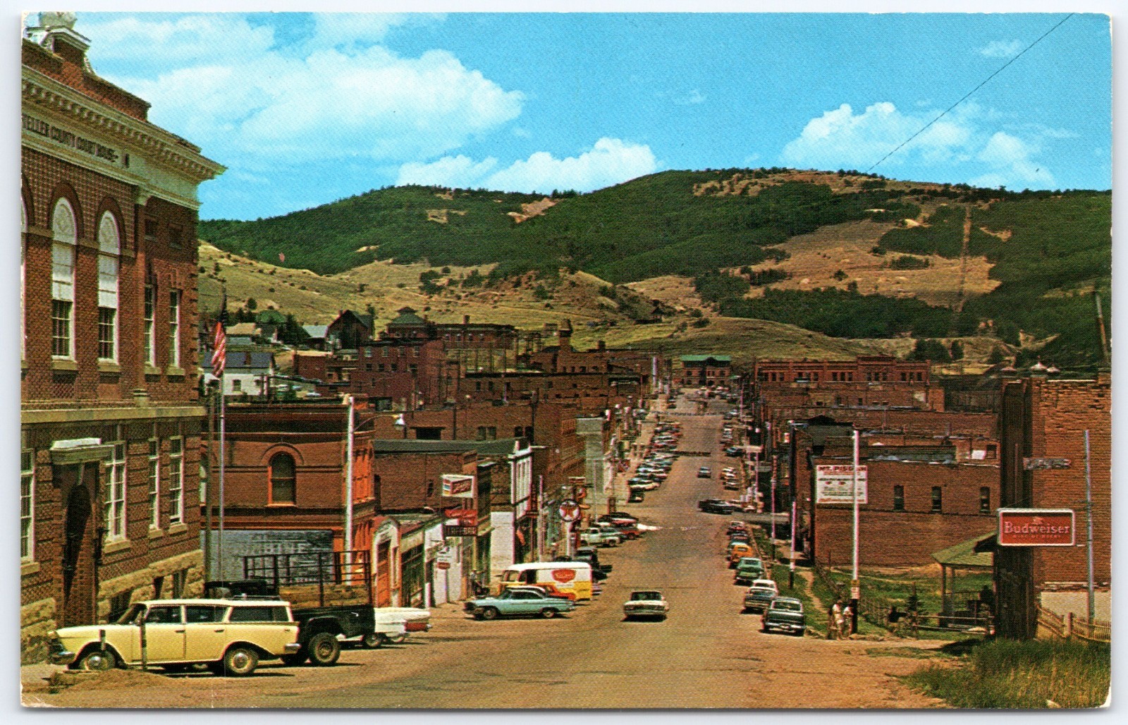 Postcard CO Cripple Creek Colorado Business Section Schlitz Bud Signs Cars P18G