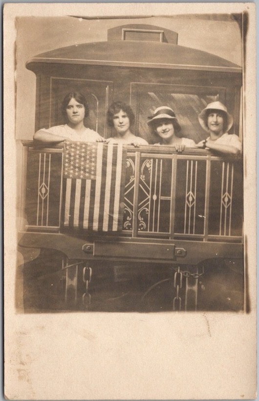 c1910s Studio Photo RPPC Postcard Four Young Ladies on Train Caboose / U.S. Flag