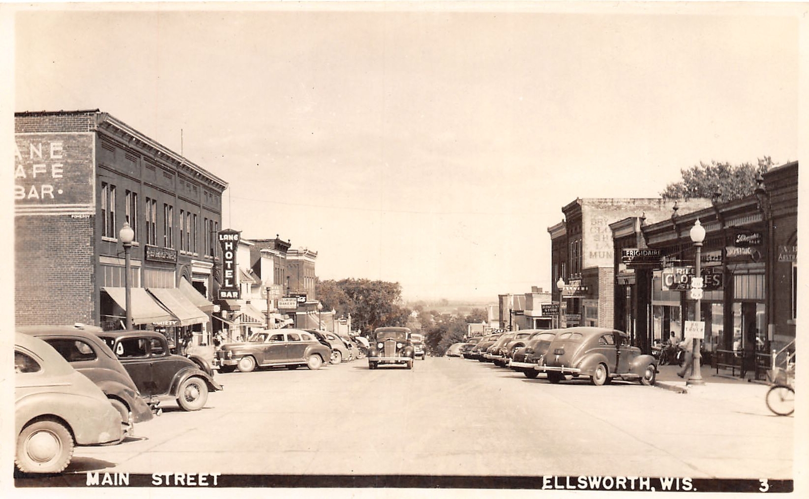 J69/ Ellsworth Wisconsin RPPC Postcard c40-50s Main Street Stores 55