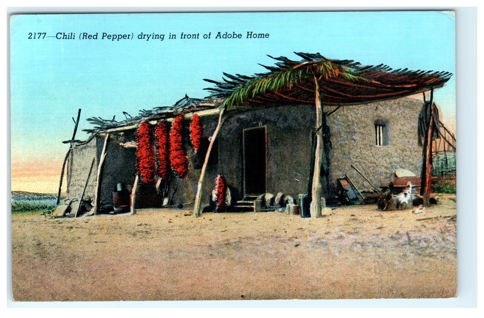 Chili Red Pepper drying in front of Adobe Home